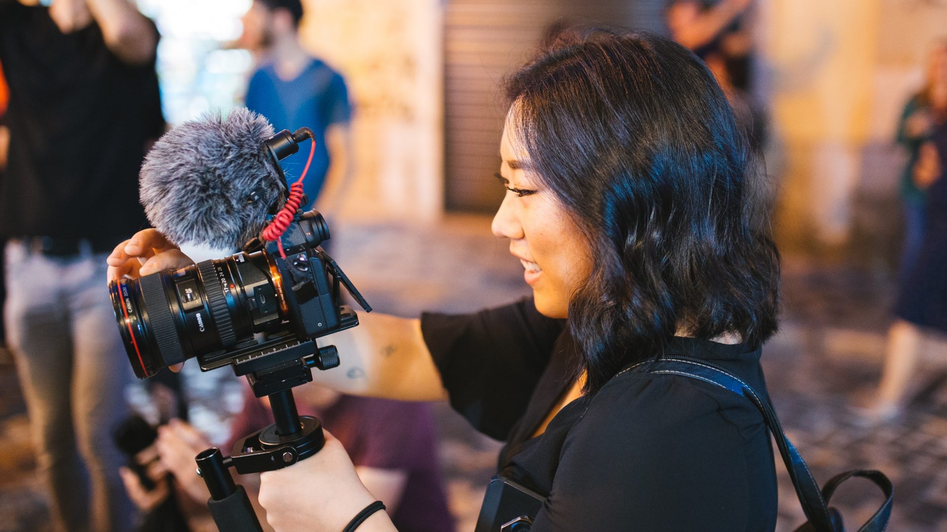 Young woman using DSLR camera